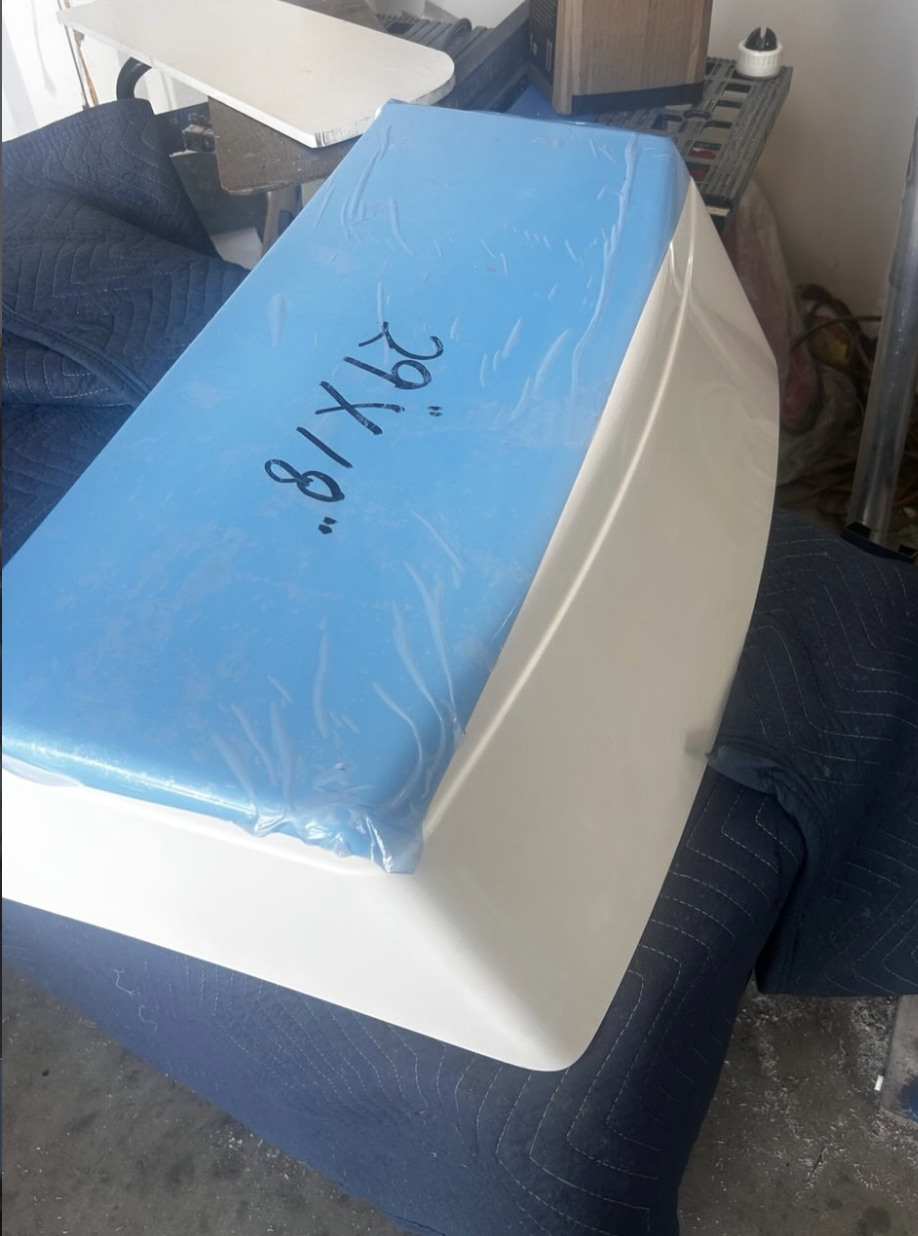 Blue cooler with white base marked "81162" sitting on dark carpeted floor