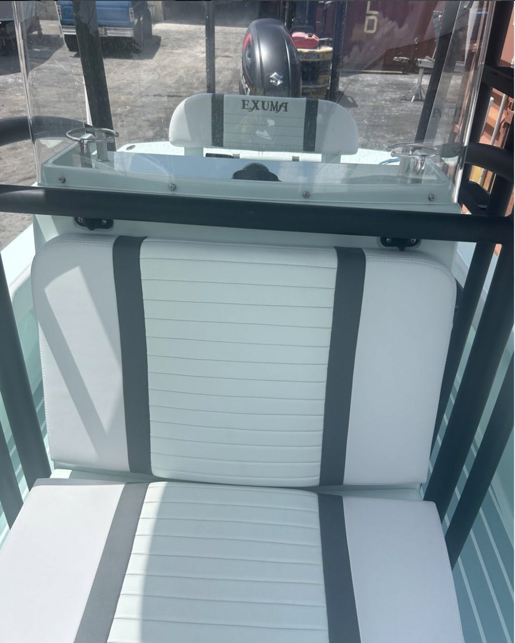 Interior view of white boat seating with black straps and windscreen display
