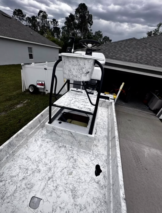 Concrete mixer mounted on truck bed in residential driveway